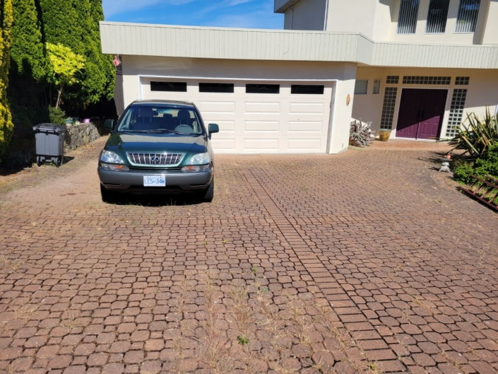 older paving stone driveway before photo