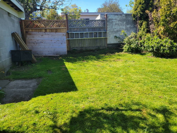 Backyard gravel and paver fire pit lounge before