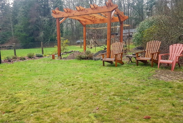unfinished backyard with chairs and gazebo
