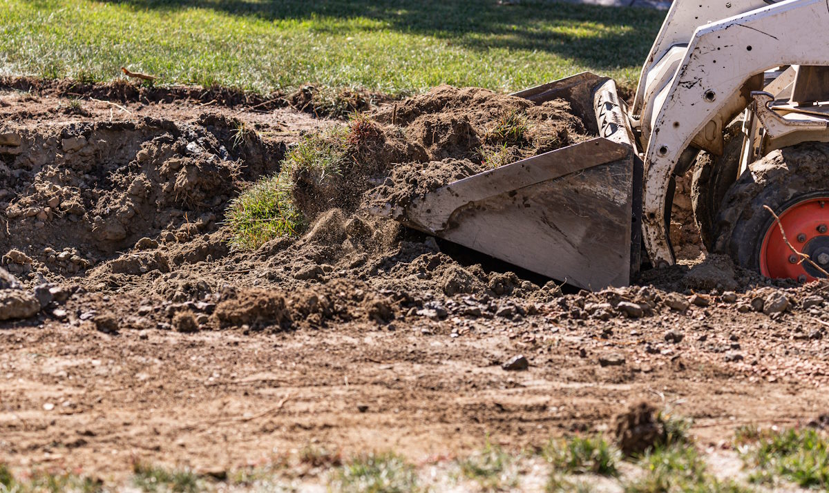 excavating yard with small bulldozer 